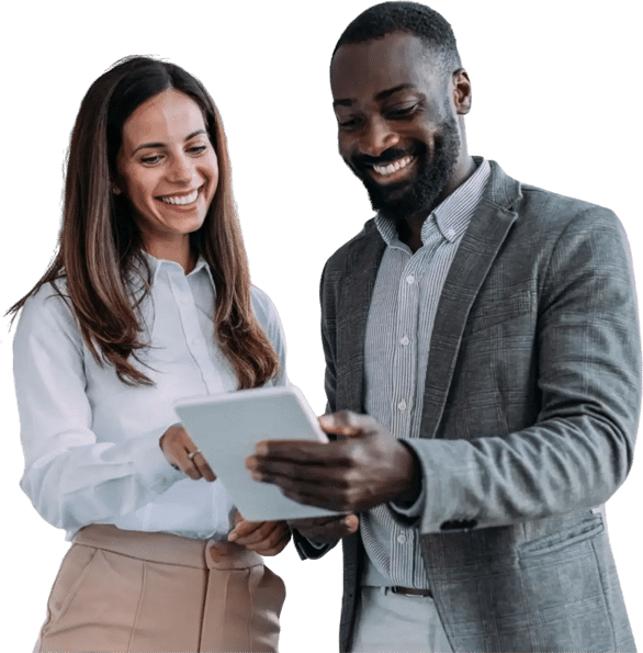 A smiling man and woman in professional attire stand together looking at a tablet held by the man.